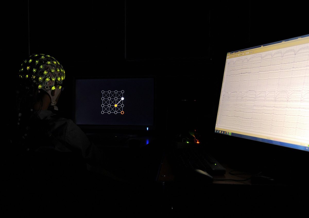 A participant wearing an EEG cap during a brain-computer interface experiment